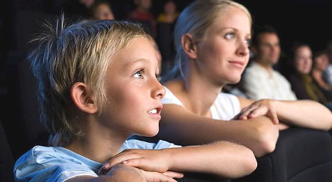 Boy and mum watching school musical